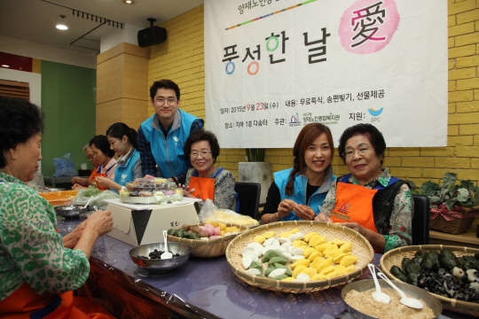 SPC그룹 임직원들이 23일 서울시 서초구 양재노인종합복지관에서 어르신들과 함께 송편을 빚고 있다.   SPC그룹 제공